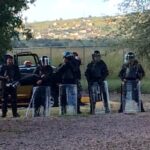As observers approach peacefully to ask a few questions, riot police take up position.