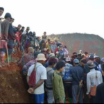 Workers taking in the level of destruction.
