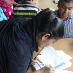 A TTL workers signs up to receive compensation after the factory was condemned. 