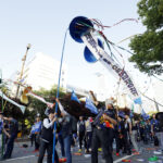 Three pinatas were opened spilling out confetti and the three bills that workers are calling enactment  Photo: SHIN, Dong-Jun