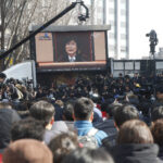 People in Seoul gather on the streets to watch the court decision live. Photo: KCTU