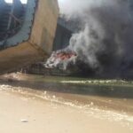 Toxic smoke belches from the burning ship.